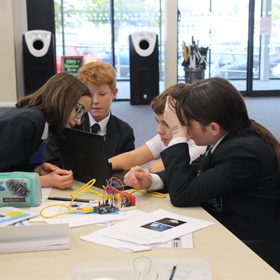 ​​​​​​P​upils enjoying tackling a coding-based problem.