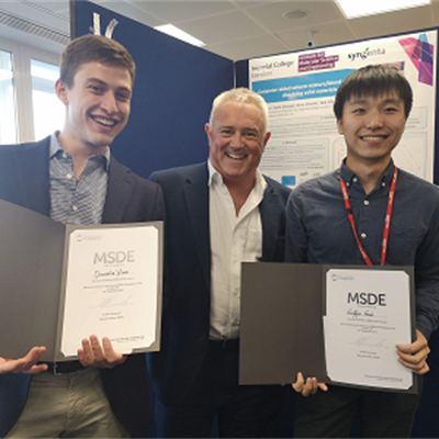 ​​​​​​​​​Daniele Visco and Griffin Gui being presented their prizes for best MRes posters by Prof. Julian Eastoe