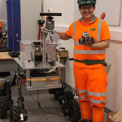 Dr Xin Ran Liu with a Lego Mindstorm Rover and a full-size Mars Rover prototype at Boulby Underground Lab
